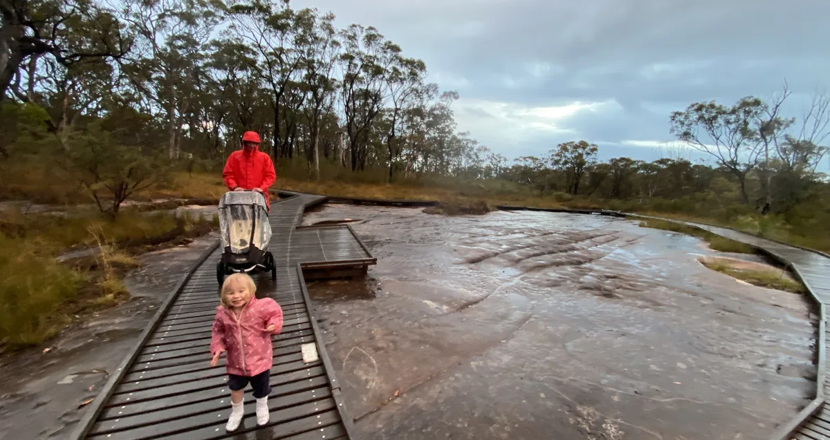 Image of a little girl at bulgandry aboriginal engravings with dad
