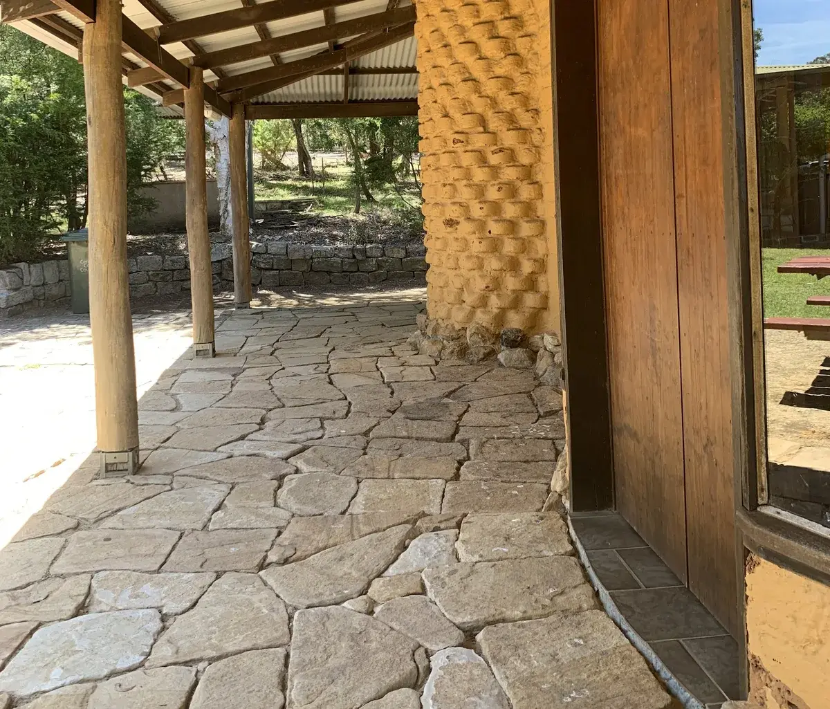 Adobe kiosk veranda with flagstone paving at the Kincumber picnic area