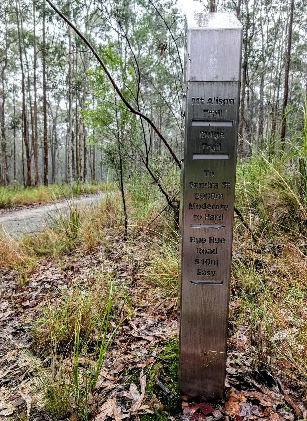 Metal trail marker showing distances along the ridge trail