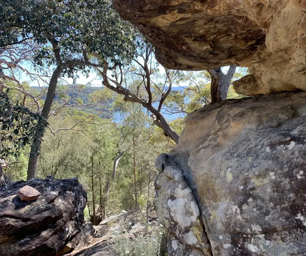 Sandstone overhang framing a bushland view along the Nagari Road loop
