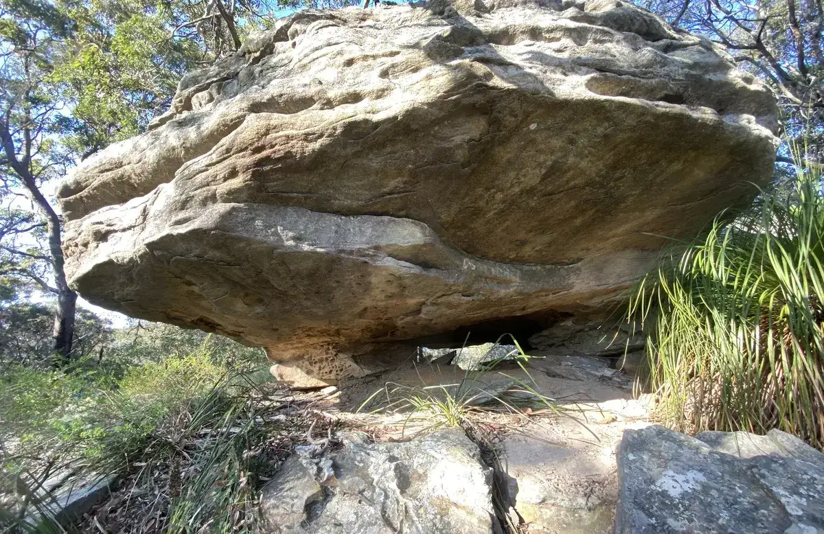 Large mushroom shaped sandstone boulder beside the walking track