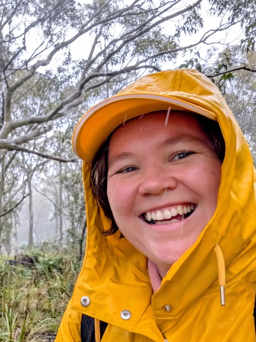 Shea Cullen smiling in the rain on a Central Coast bushwalk