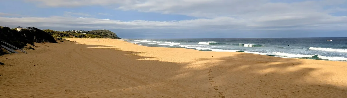 Wide view of Wamberal Beach curving toward the Terrigal headland