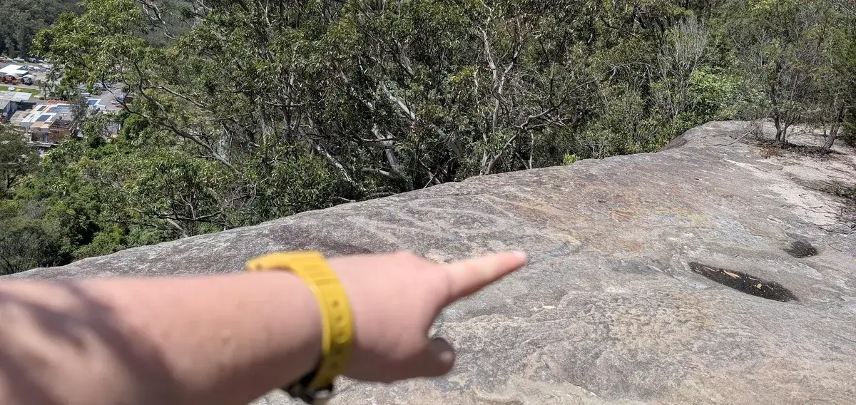 Hand pointing directions to Woy Woy Falls