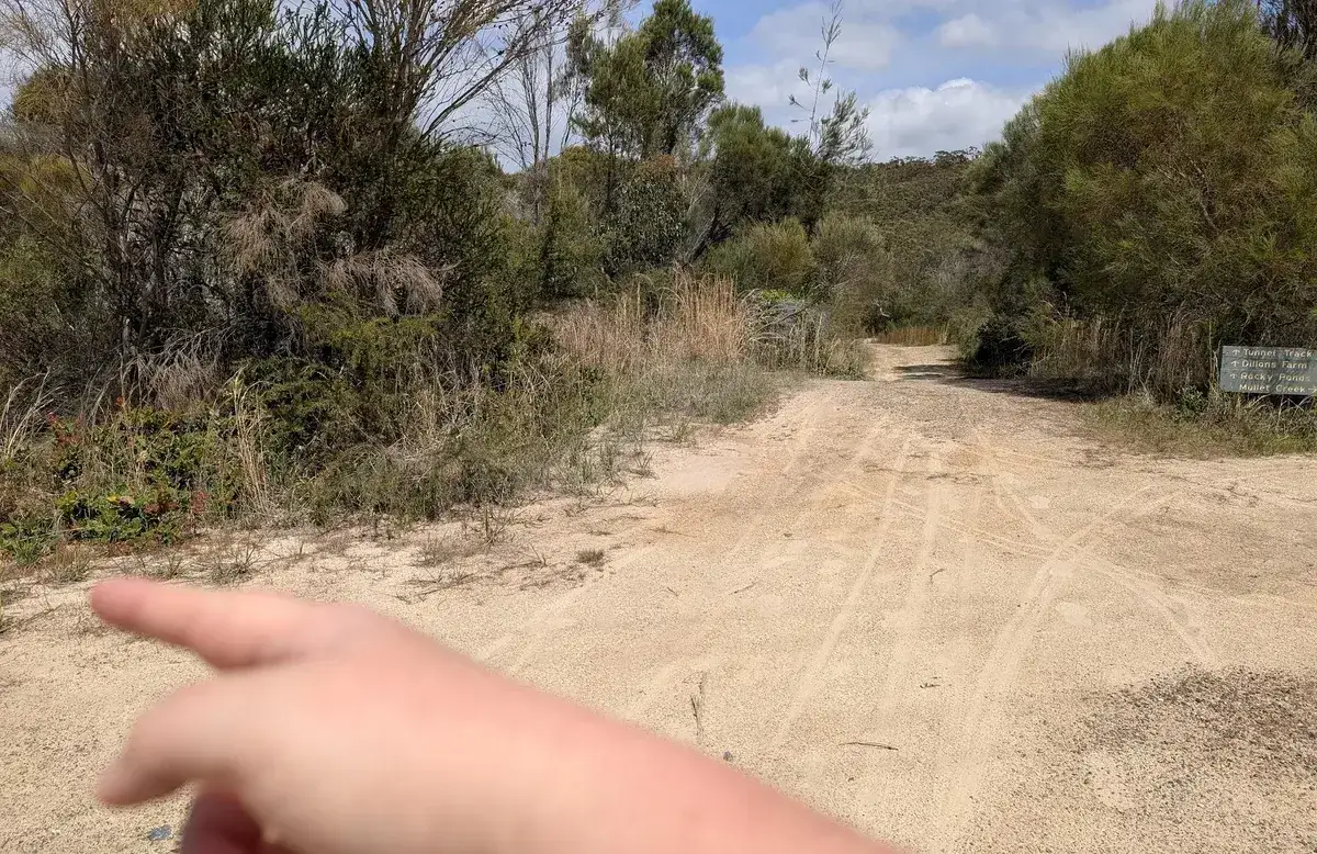 Hand pointing directions to Woy Woy Falls